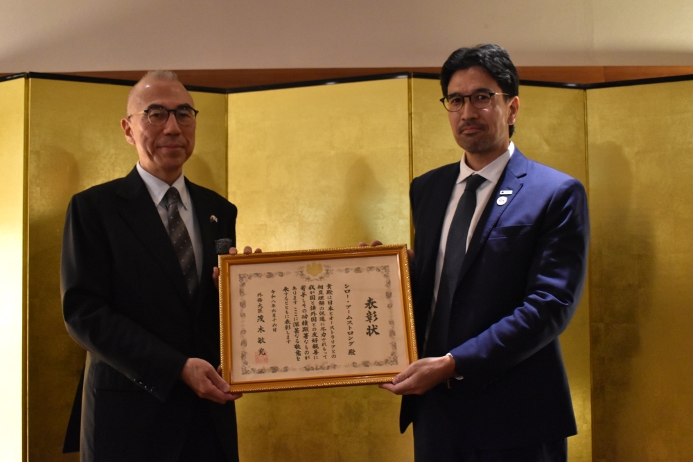 外務大臣表彰を鈴木大使とシロー氏が持っている写真